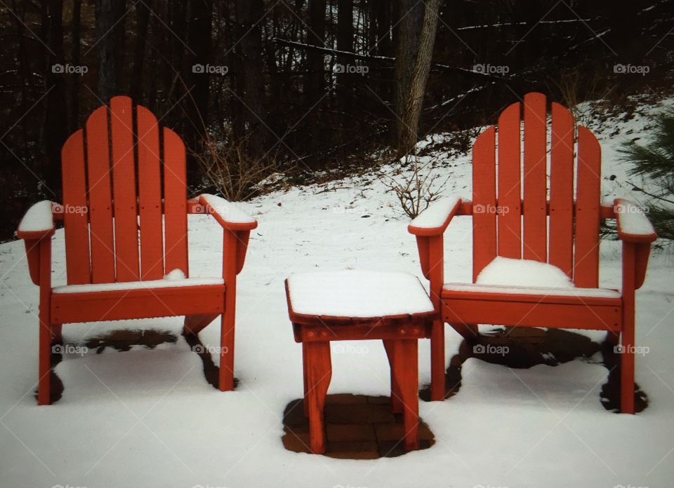Adirondack chairs in the snow
