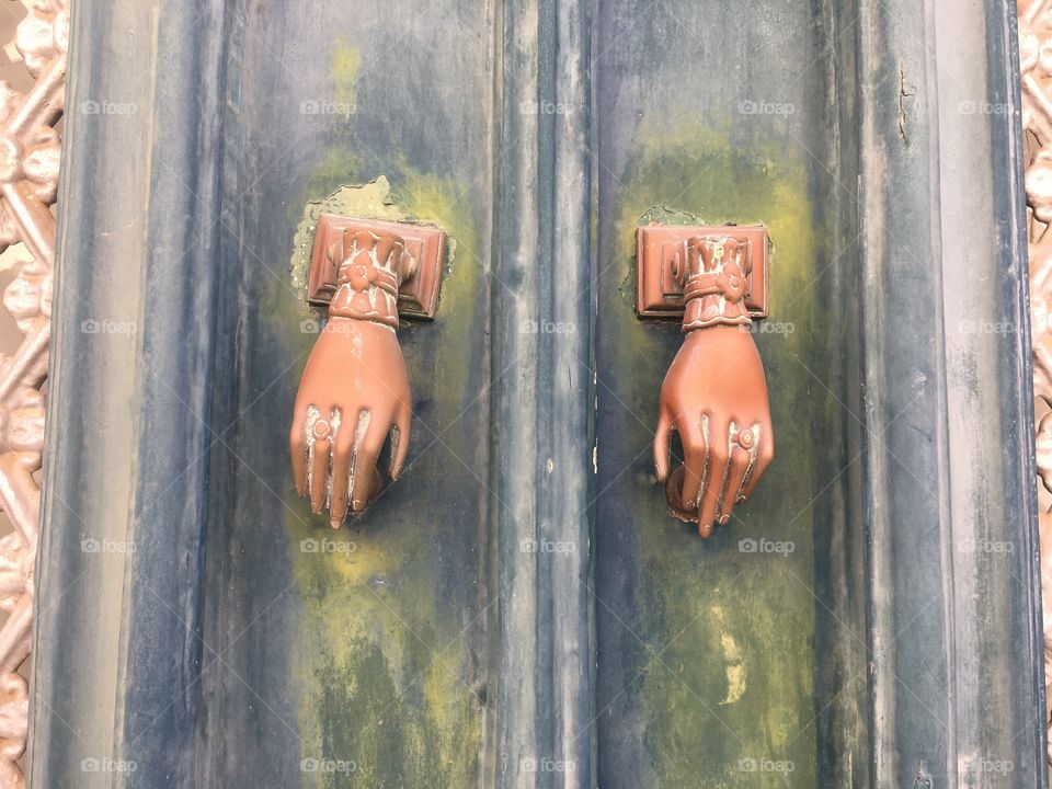 Two hands as door bells
