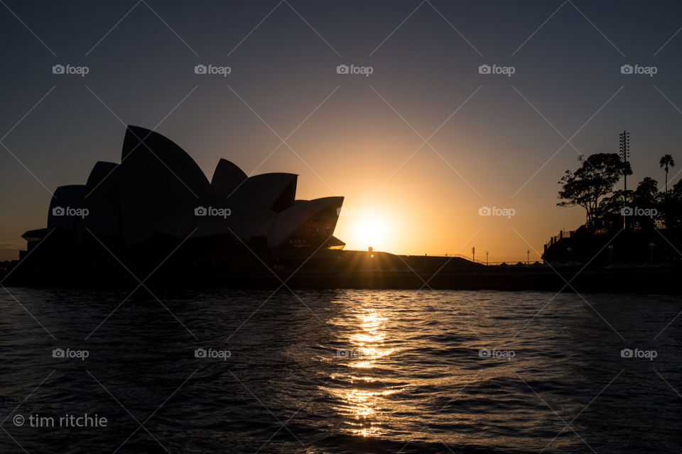 Sunrise on Sydney Harbour with the Opera House in silhouette