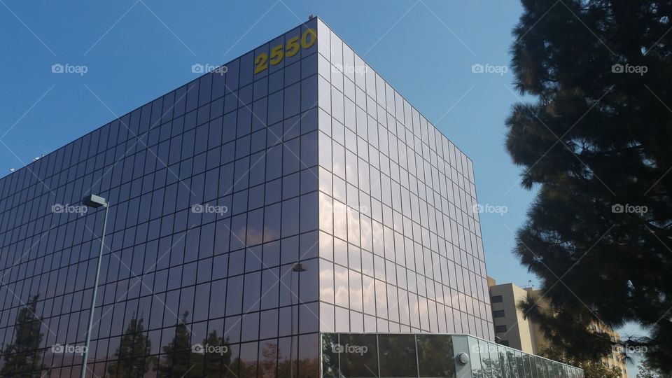 Clouds Reflected In Glass Widows Of Office Building