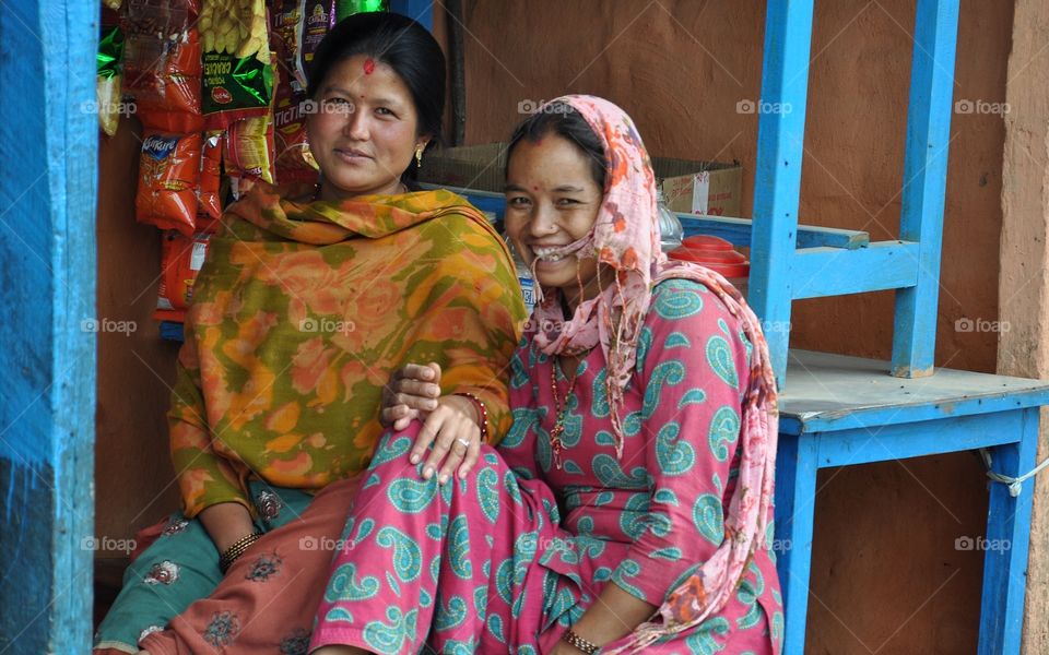 pretty smiling nepalese women sitting in front of the shop not far from kathmandu