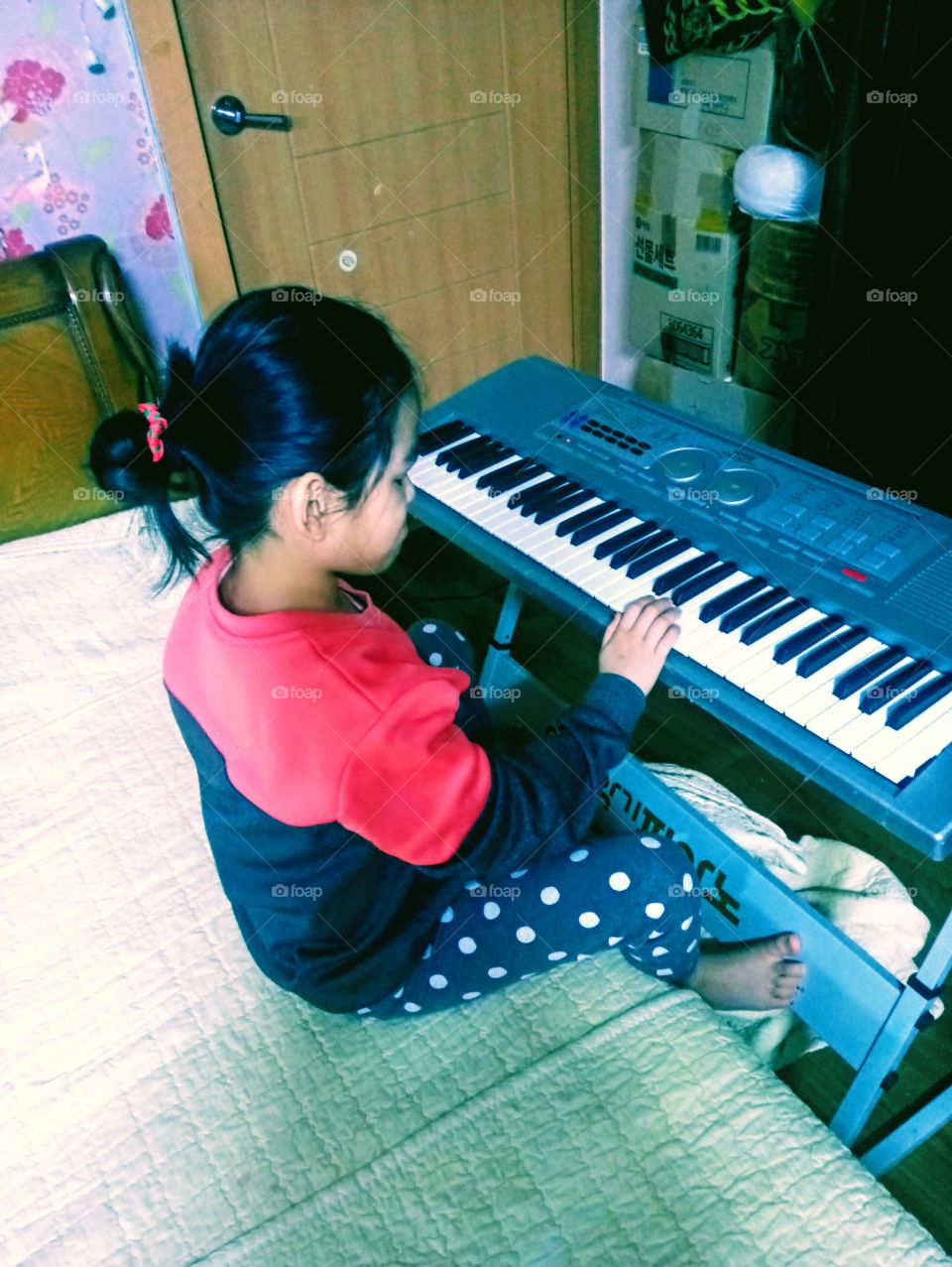 the korean little girl loves to play piano for it gives her relaxation and happiness.