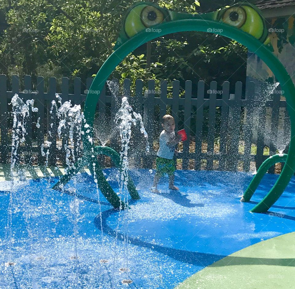 Child playing in fountains 