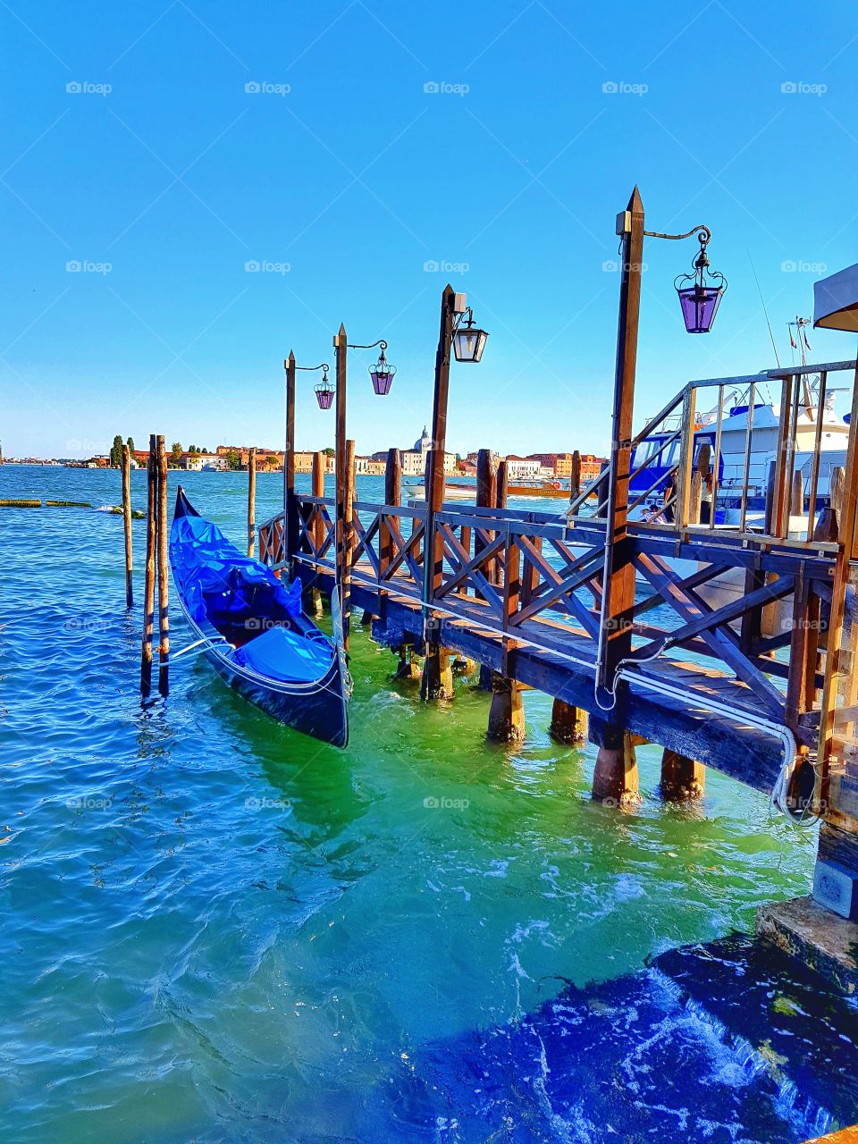 Boat docked at wooden pier