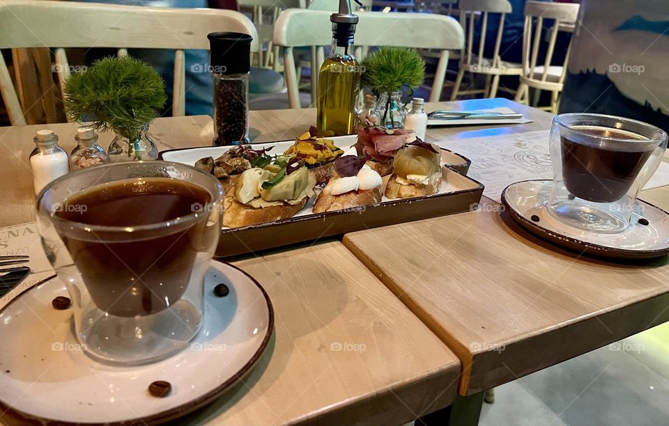 A cup of coffee with some coffee beans as a decoration 