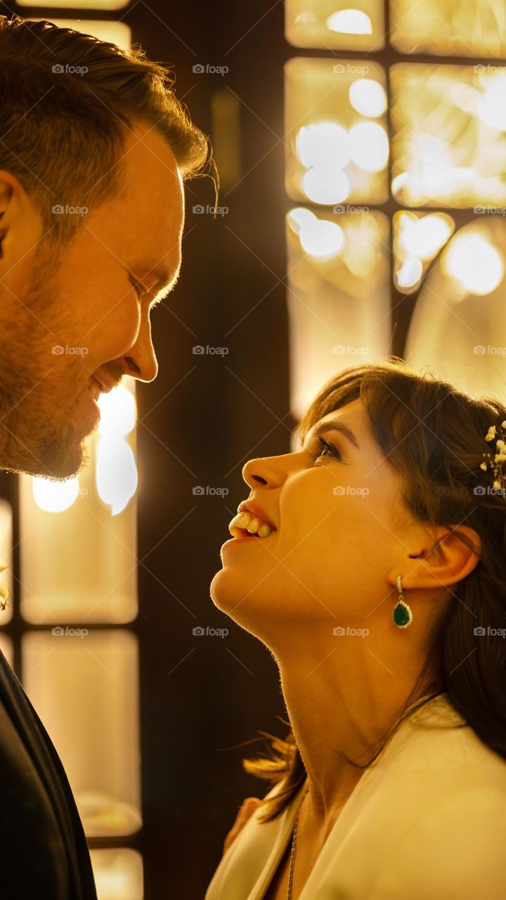 Portrait of a young couple. The bride looks at her fiance in love