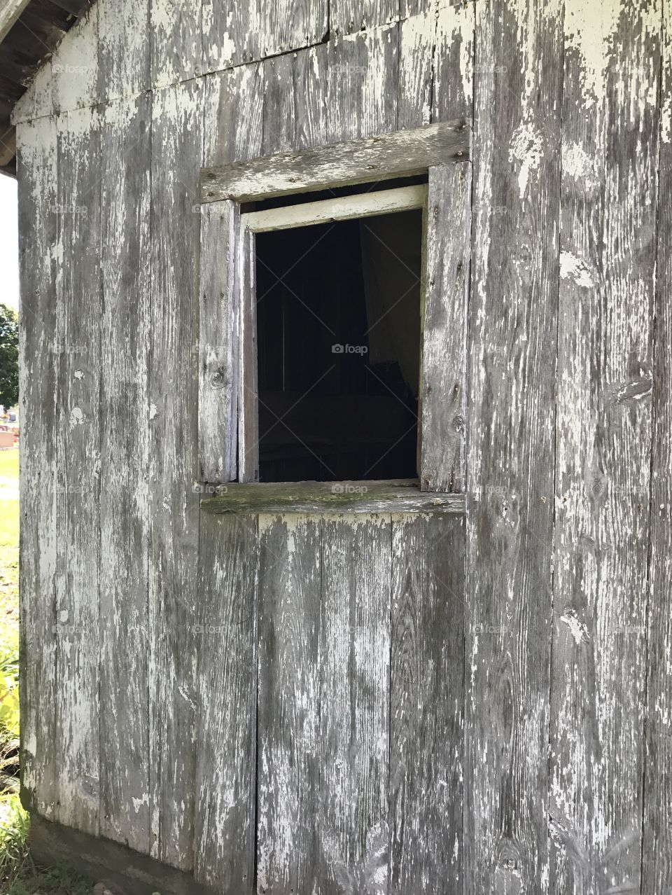 An open window of an old shed.