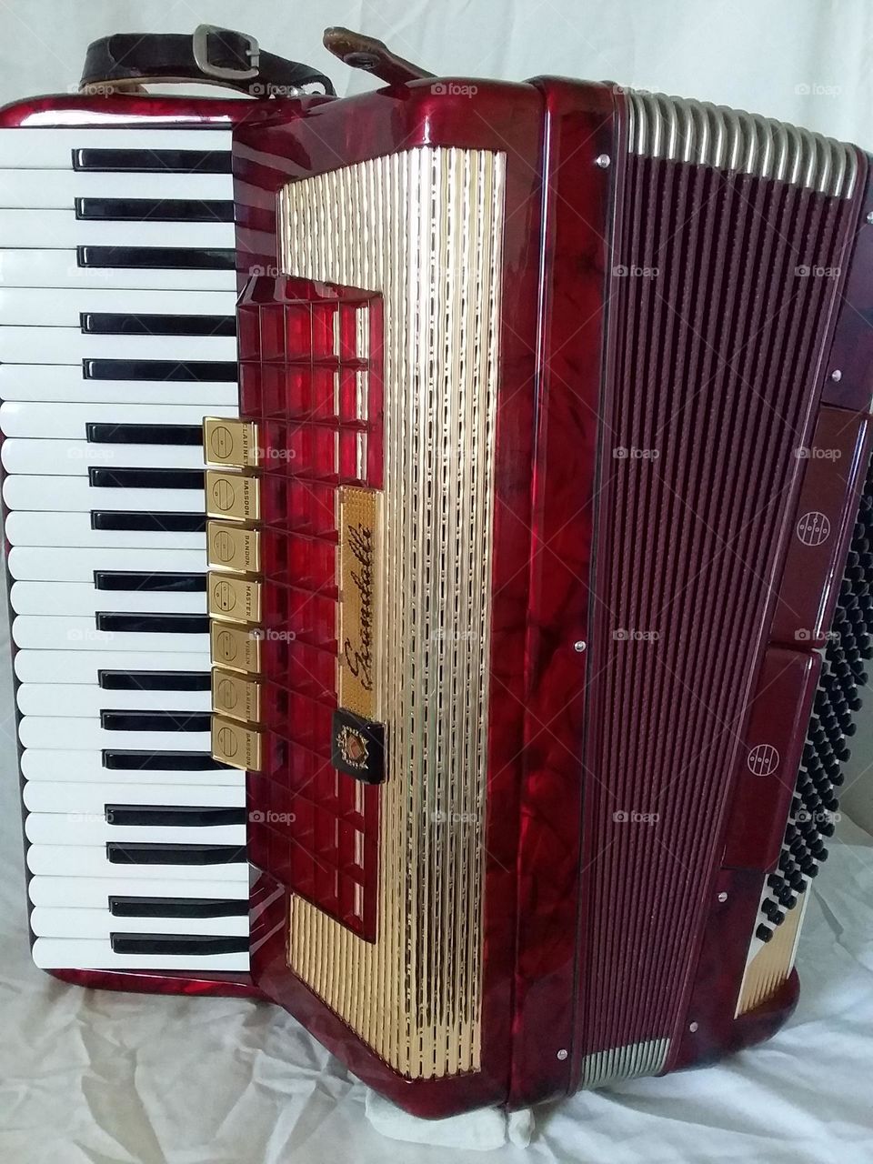 a beautiful red and gold Scandalli piano accordion