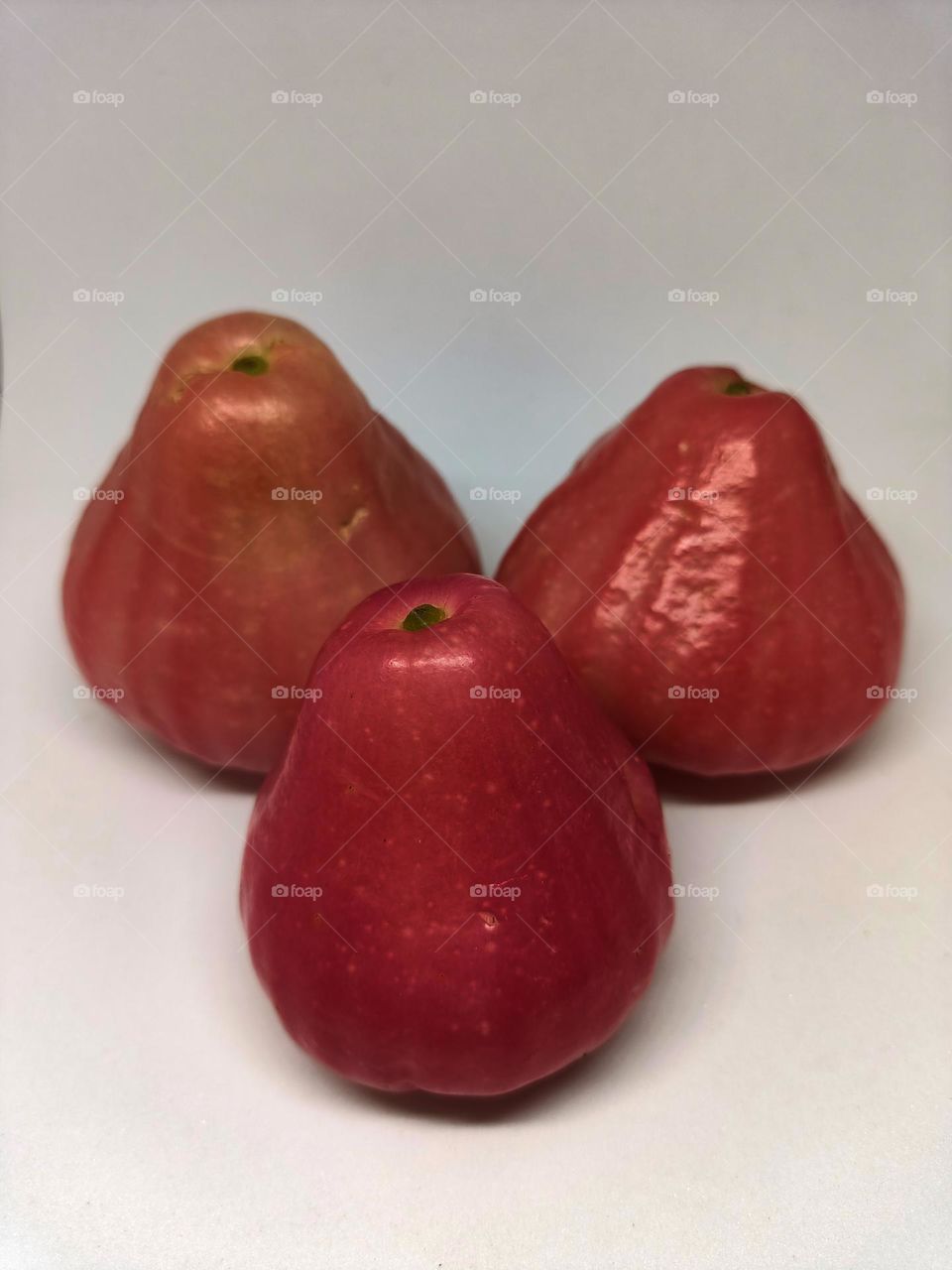 Close up of wax apple isolated on white background. Selective focus, underexposed, blurry, low light, too soft