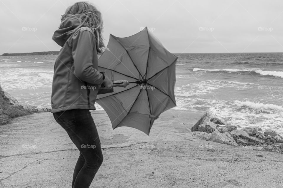 girl and her umbrella at the coast