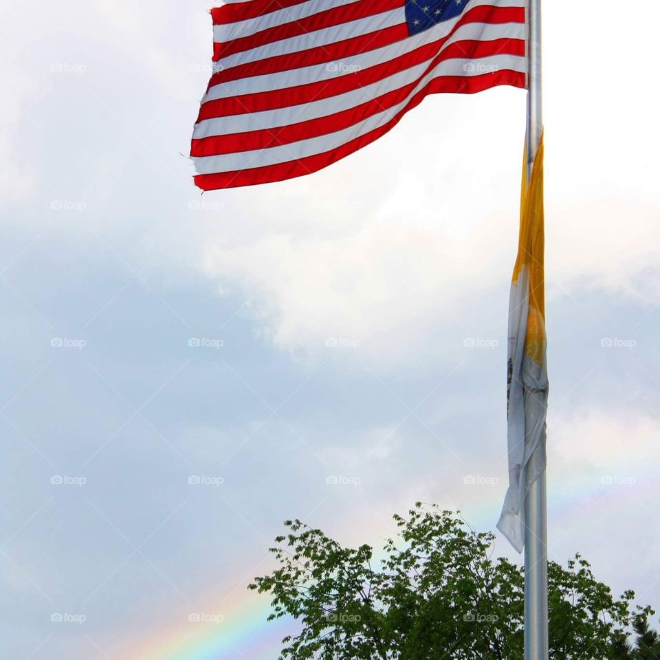American flag with rainbow in the background