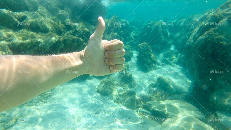 thumbs up underwater