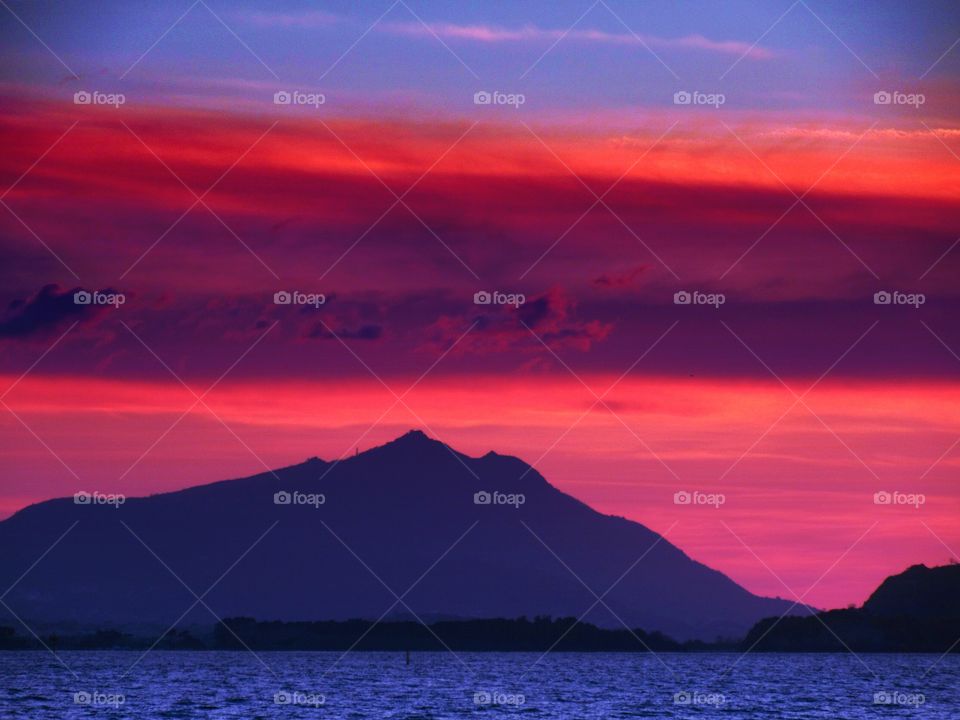 Red Clouds over  the Island of Ischia  during the Sunset   ( Naples - Italy ).