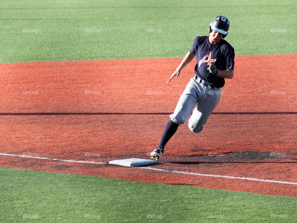 Baseball runner passing 3rd base.