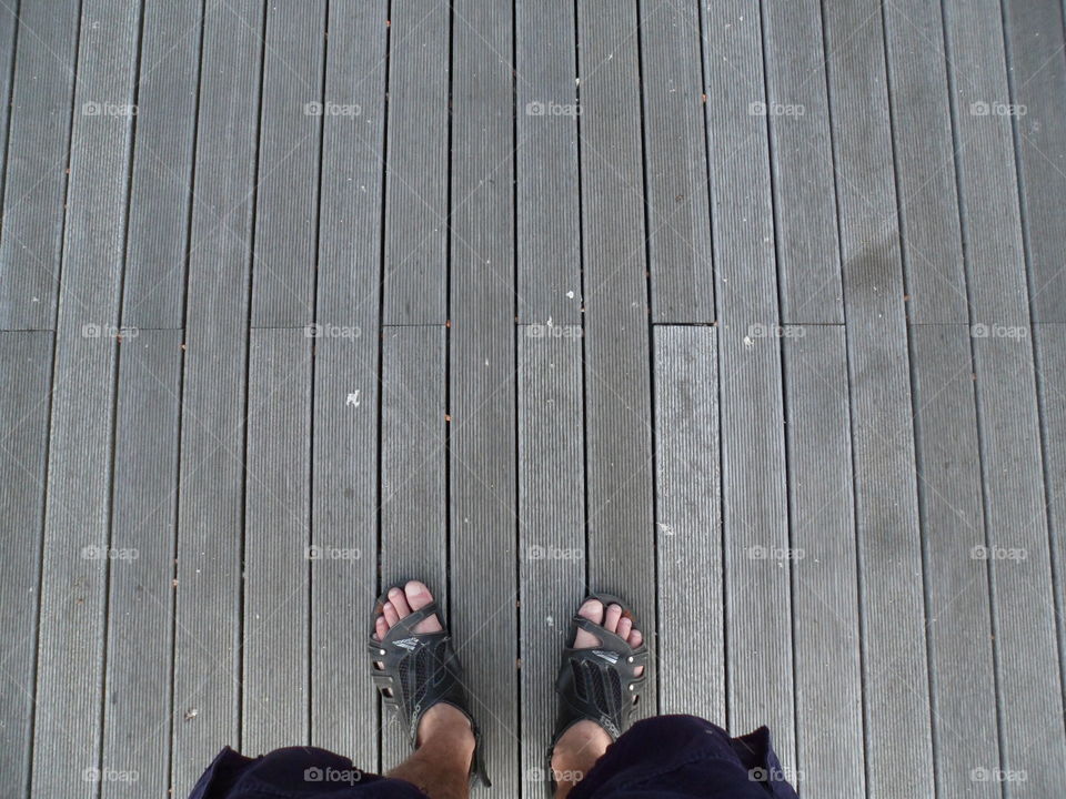 feet on the gray boards