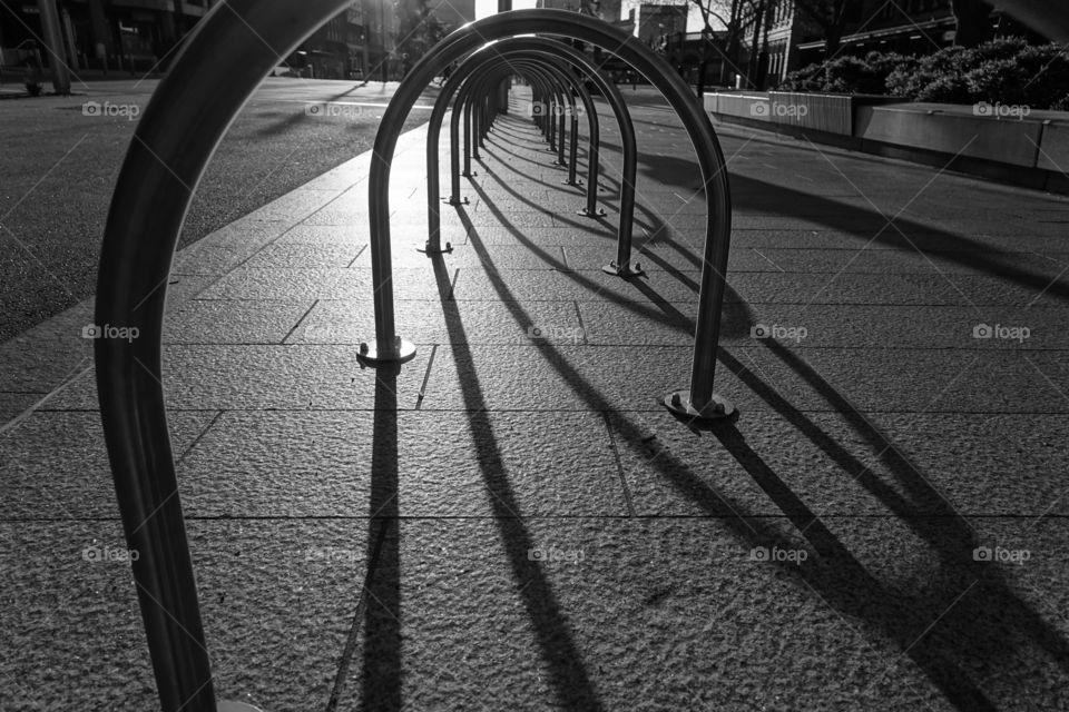 Monochrome street snap with u-shaped shadow in the magic hour.