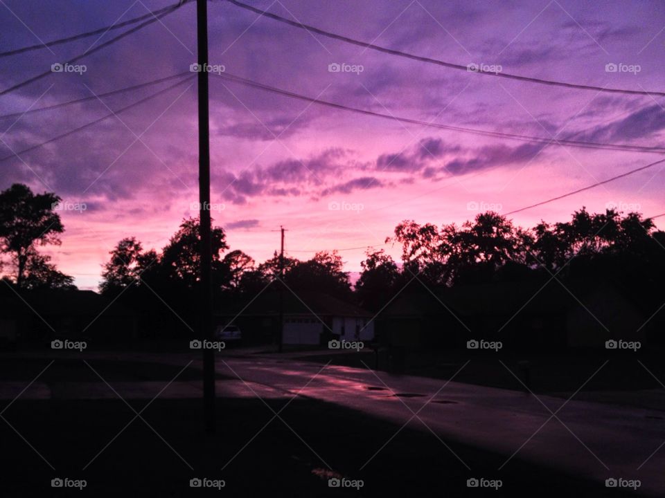 The sky turns pink and purple over a small town in rural Arkansas