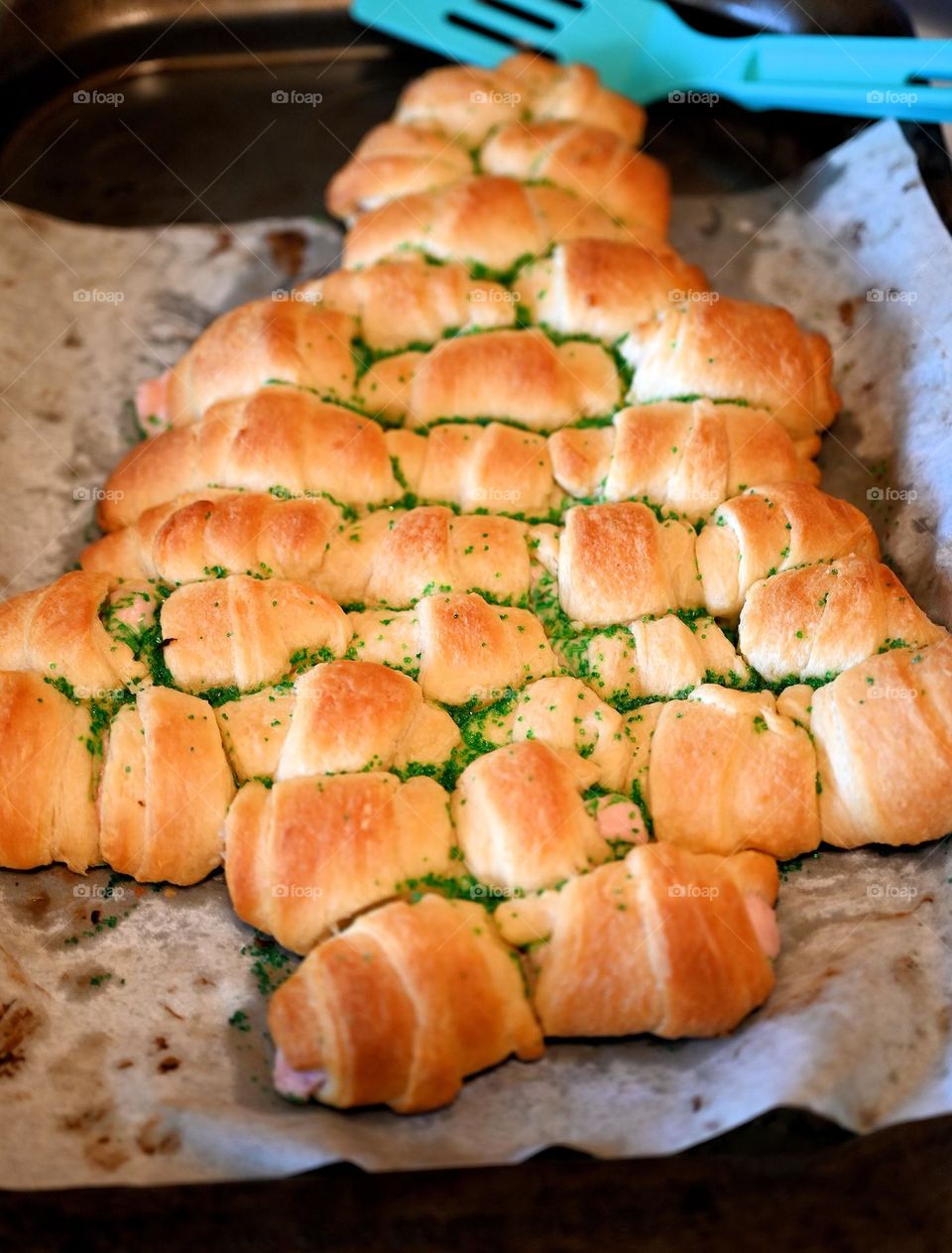 Croissant Christmas Tree formed bread freshly baked on the table for family Christmas party. 