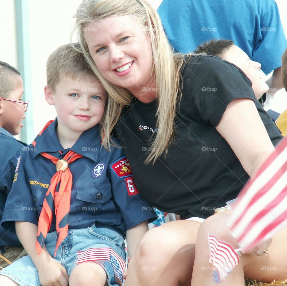 Mom and son on Cub Scout parade float. 