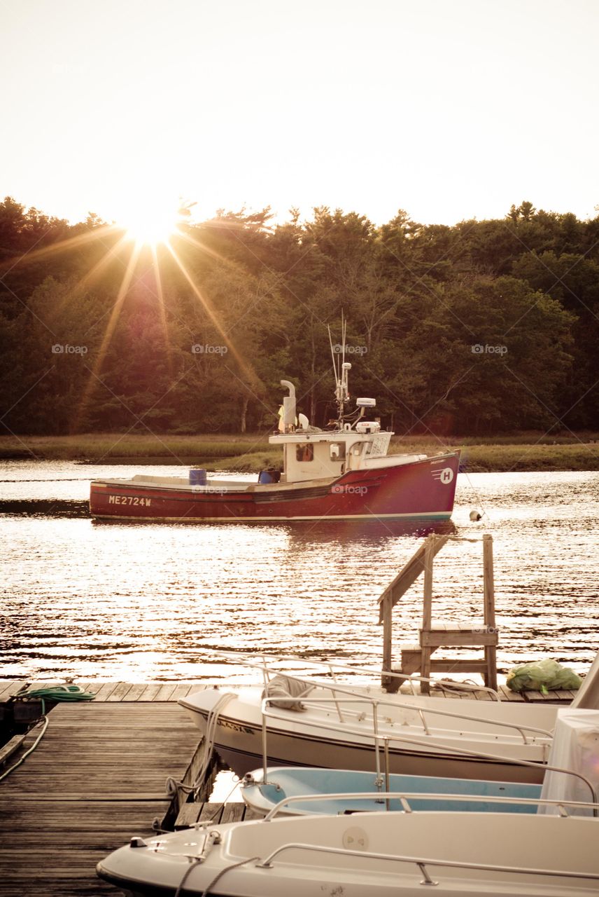 Sunset with Red and White Lobster Boat on the Water in Kennebunkport Maine Inlet