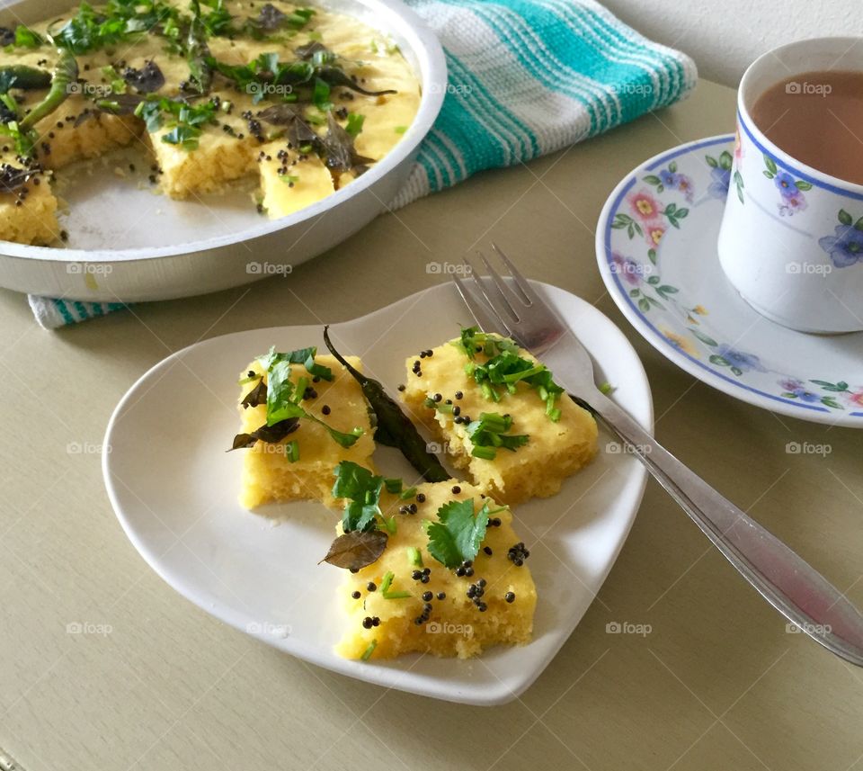 Homemade steamed garbanzo cake ( dhokla ) Indian savoury snack.