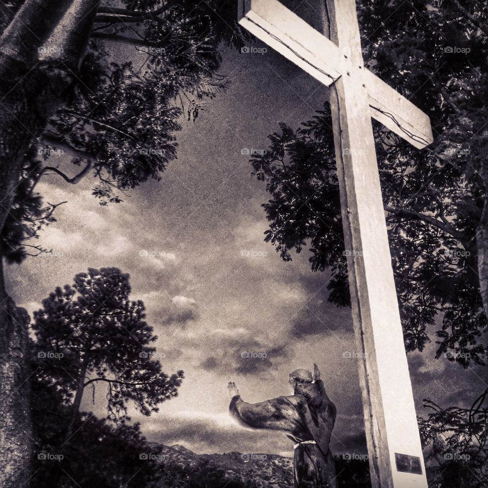 Father Serra. A statue of a Franciscan and a cross