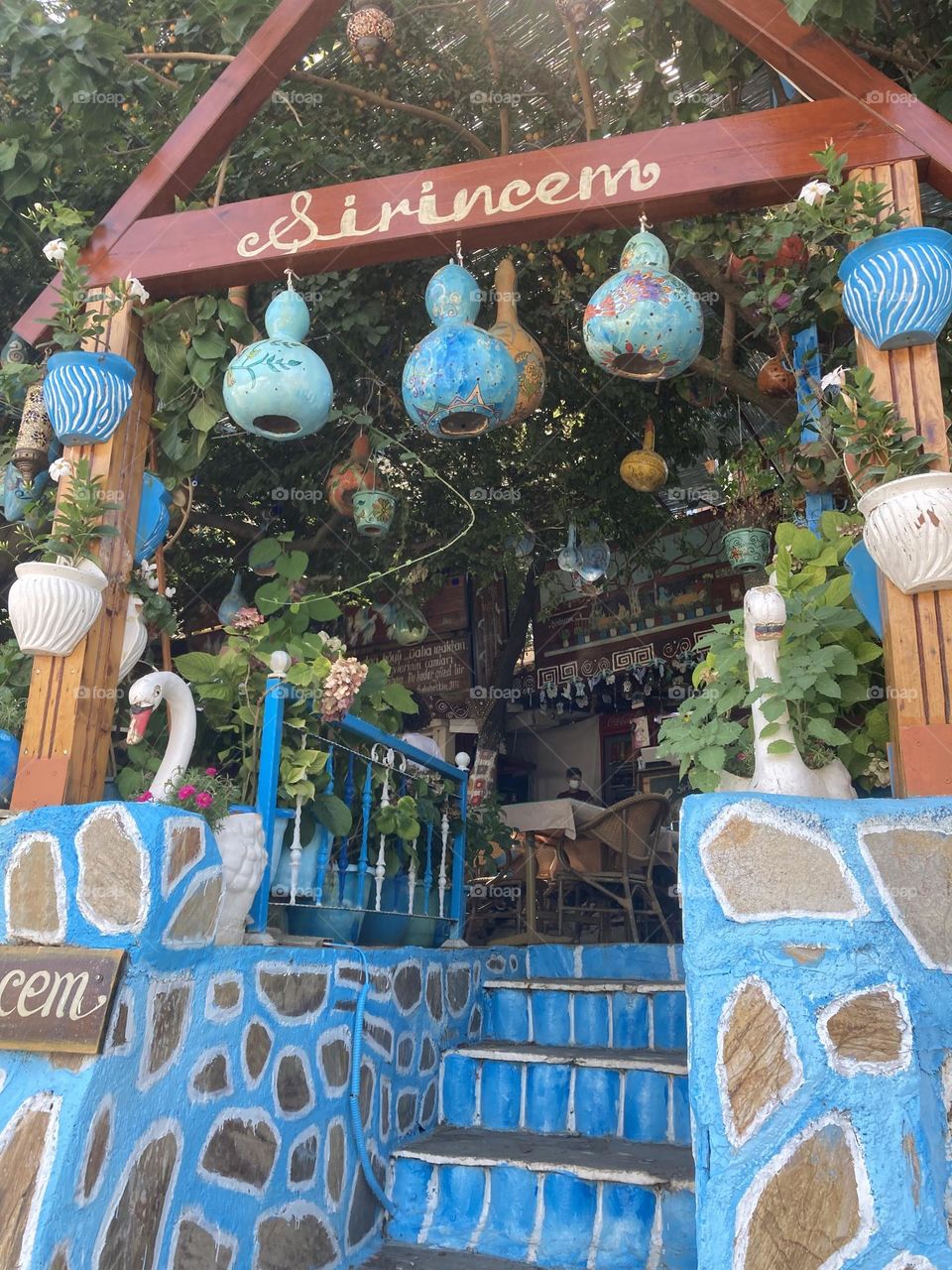 Greek village in Turkey. Blue sky and tall palm trees. Sunsets and sunny days. Summertime in Kusadasi. Vacation travel in Turkey . Summer view. Sunny day during vacation. Hidden gems and secret places.