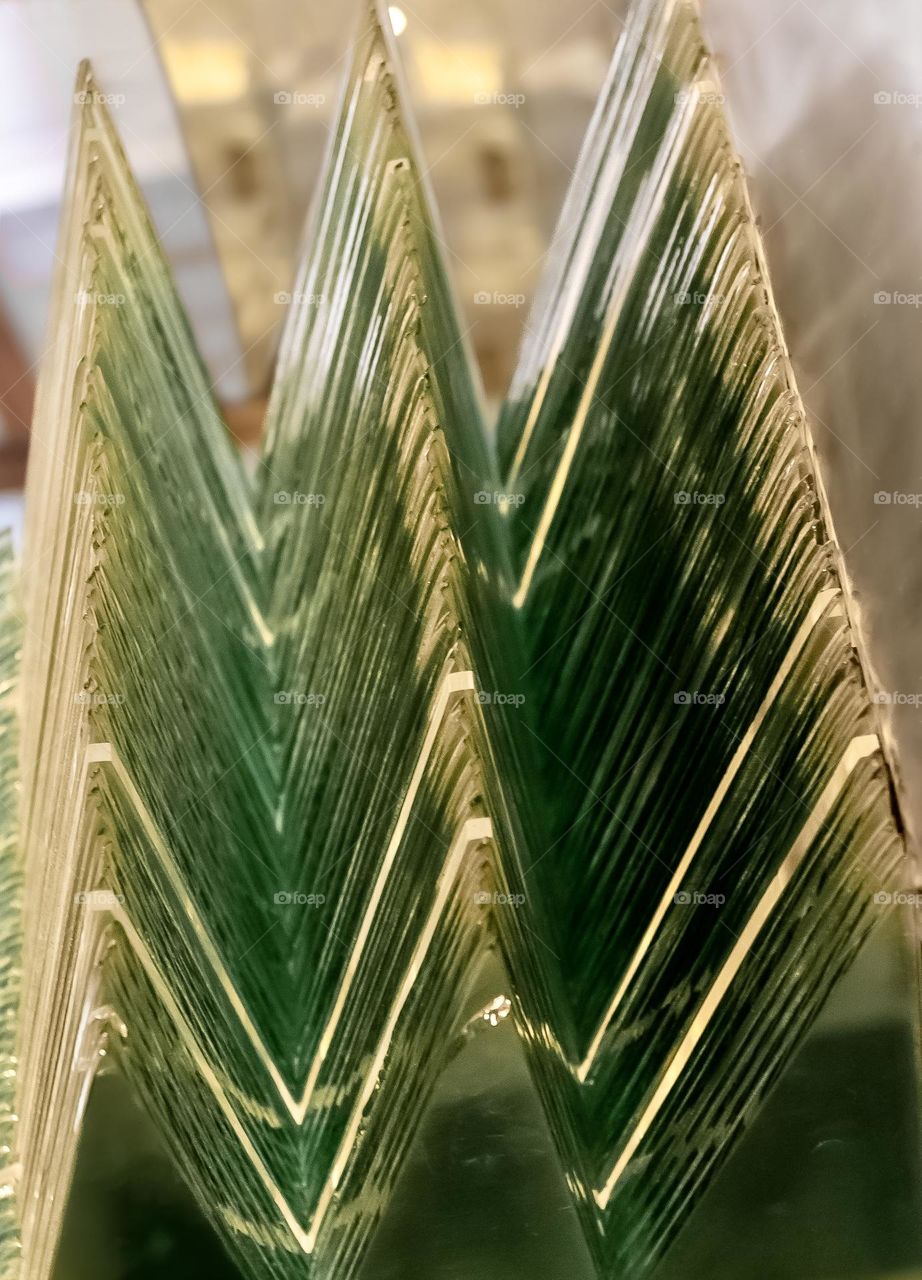 Stacks of glass cut in triangular shapes and bolted together