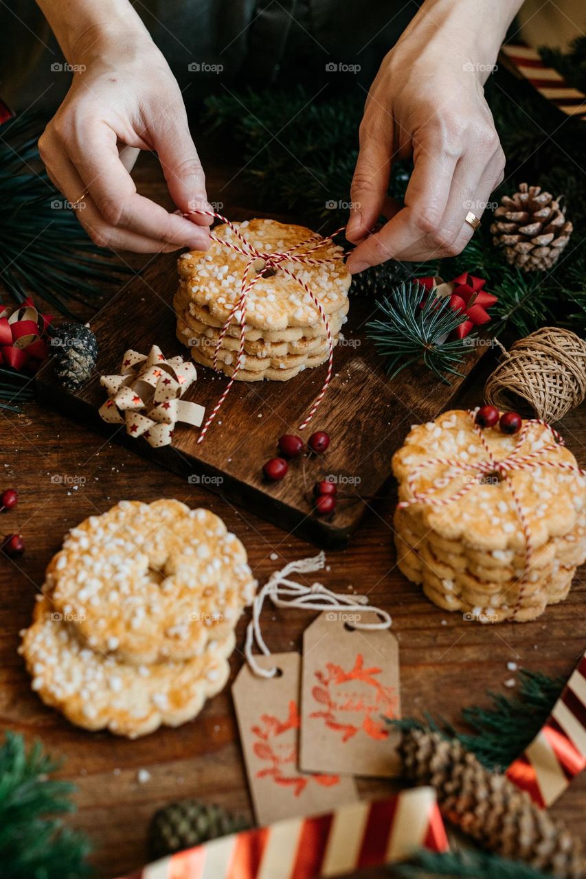 Woman packing homemade butter cookies for winter holidays.