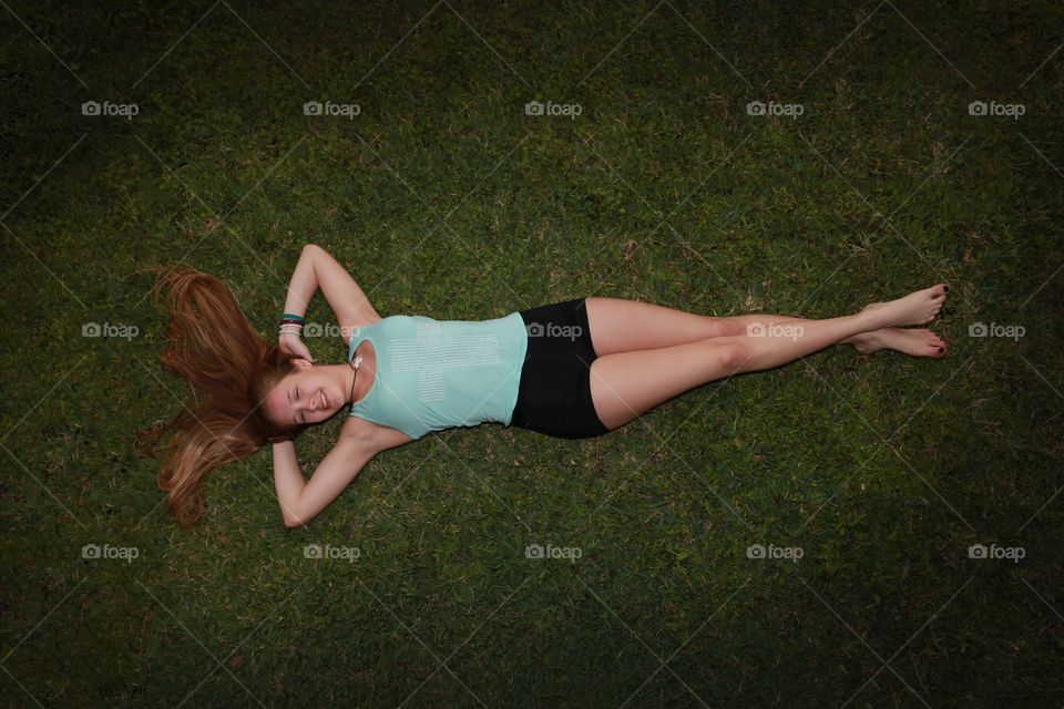 Elevated view of a woman lying on grass