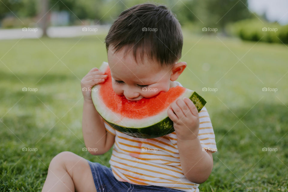 Boy enjoying watermelon on a summer day 