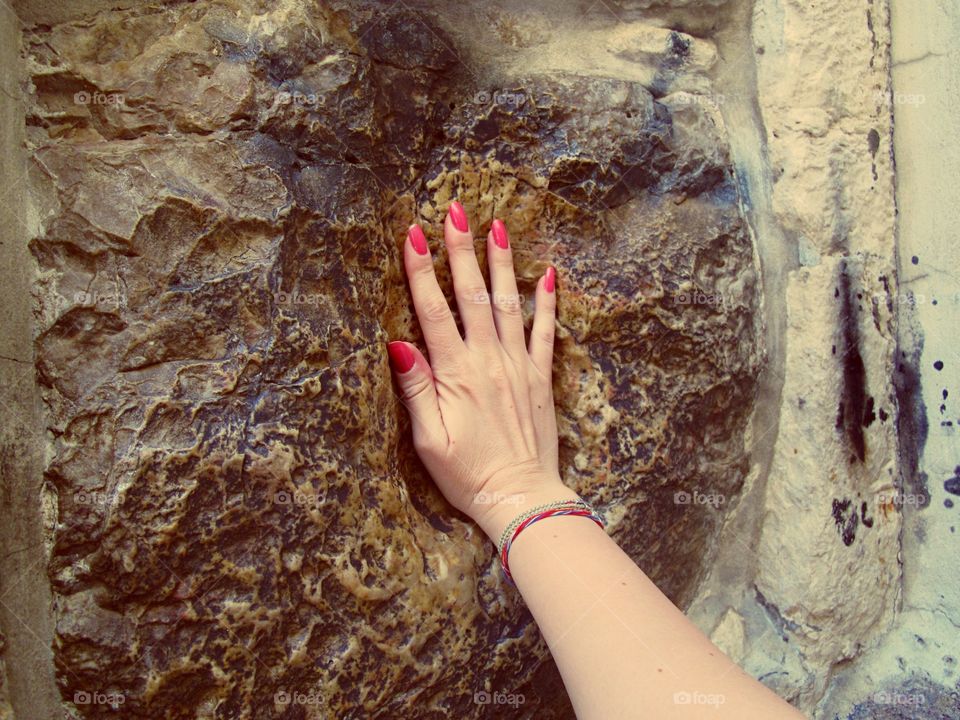 Woman hand touching rock
