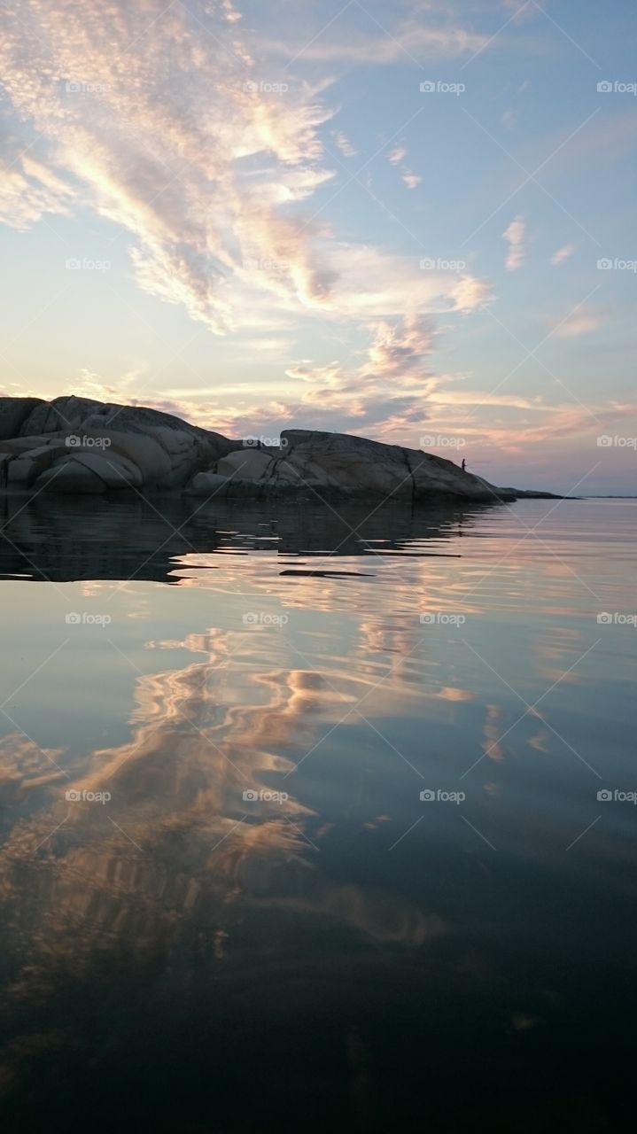 fishing from a cliff in the dawn