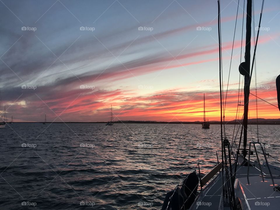 sunset with boats anchored off the coast of Portugal