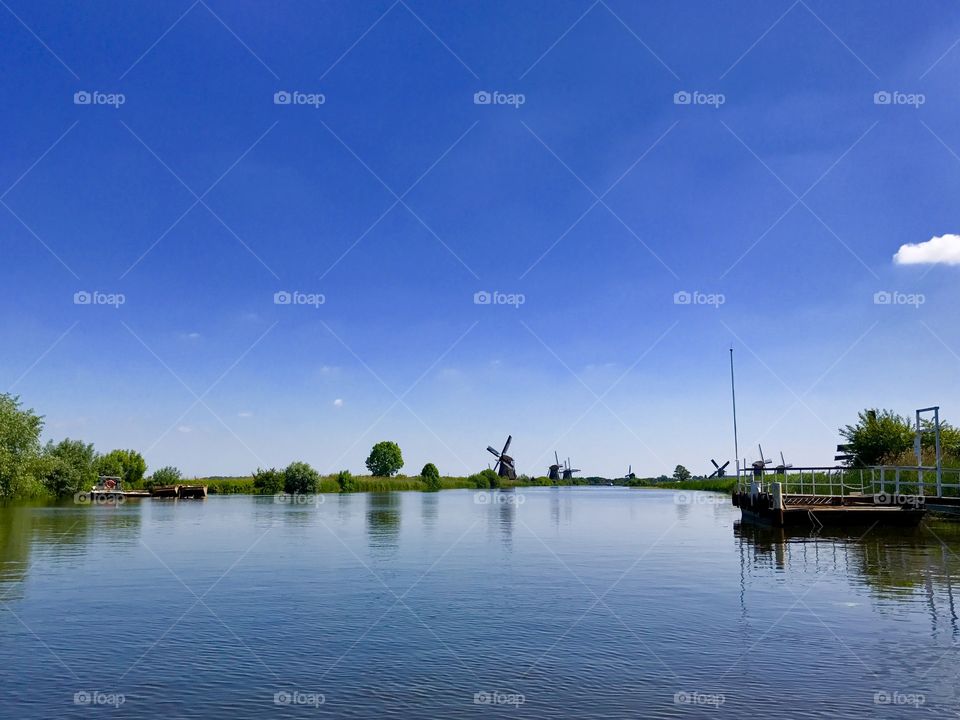 Dutch windmills on river bank, Kinderdijk, Holland 