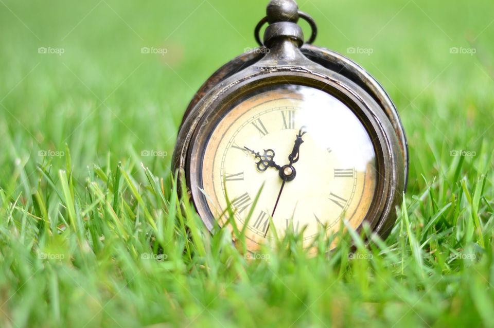 clock outside on the grass
