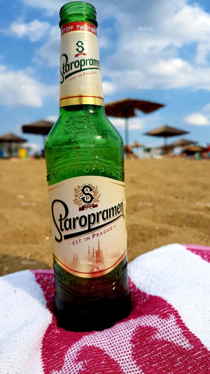 On hot days, beer is drunk on the beach towel