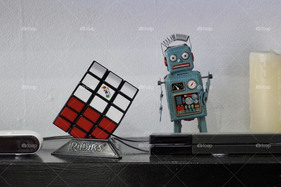 Vintage robot next to a solved Rubiks cube