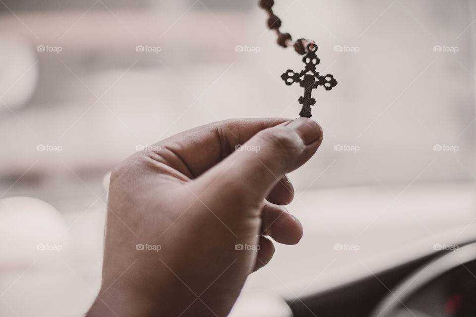 Close-Up Hand holding Rosary beads