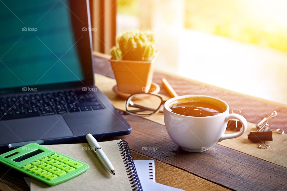 Desk work on wooden table and coffee