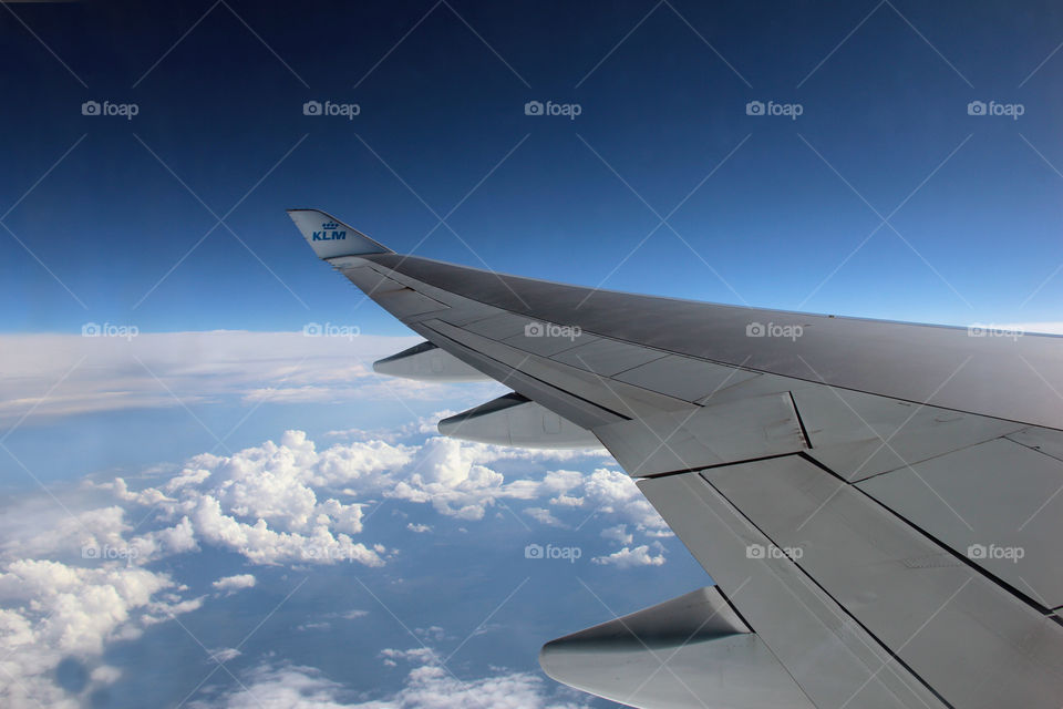 plane window view. It is still nice when you look outside through a window of the plane and you see a blue sky and the clouds below.