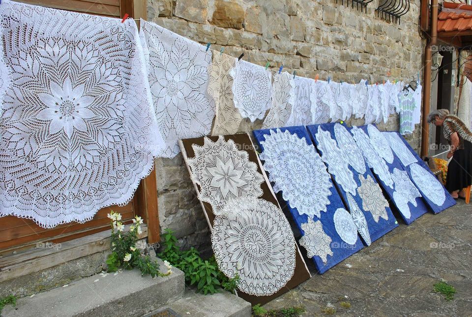 Handmade snowwhite knitted napkins and tablecloths on the street market