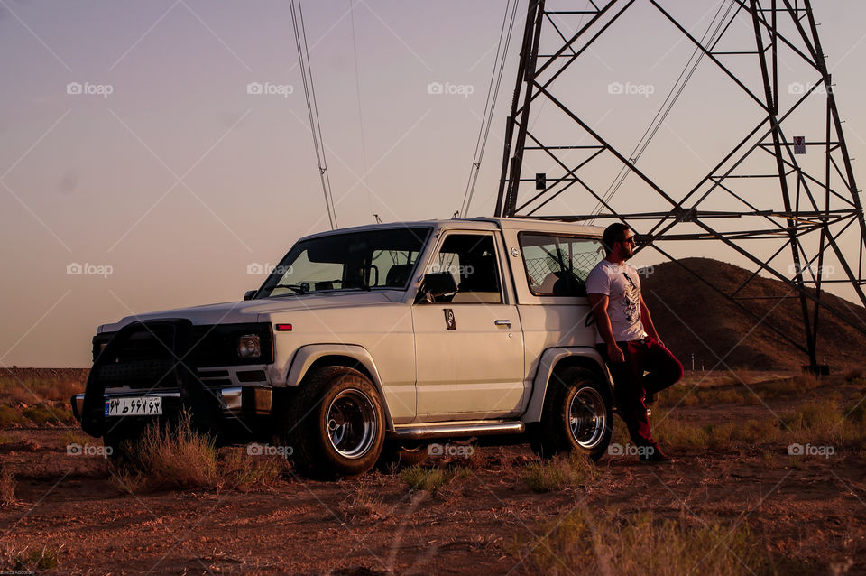 guy and his power. Offroad trip to the desert with a handsome guy and his powerful patrol at sunset. wearing t shirt