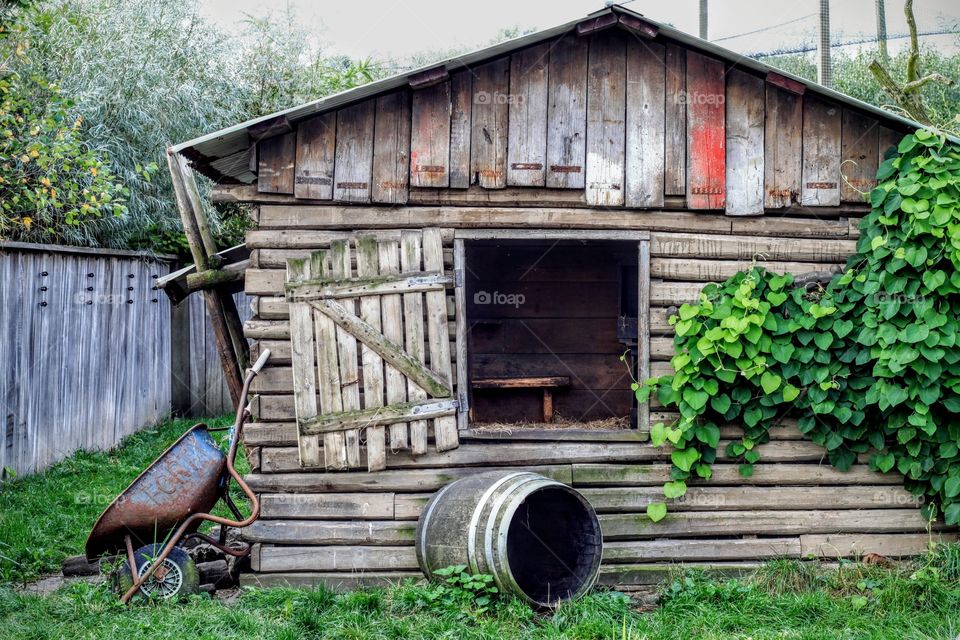 Old wooden shed, barn, barrel