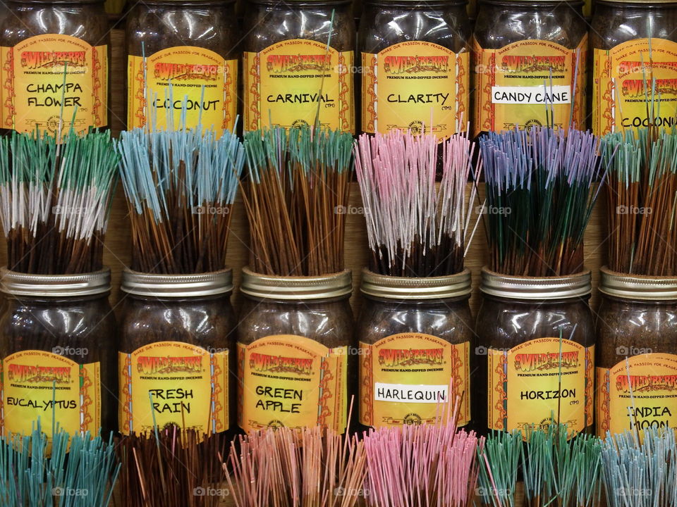 Colorful incense in jars on display.