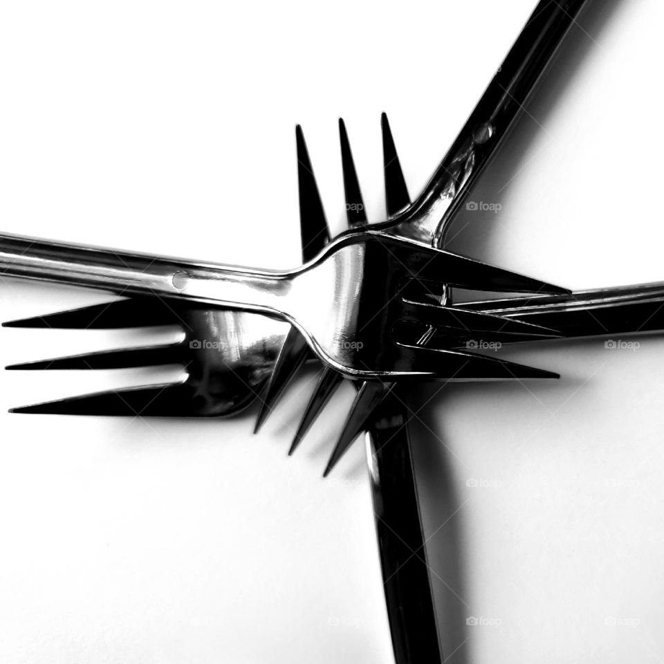 Three forks stacked in black and white.