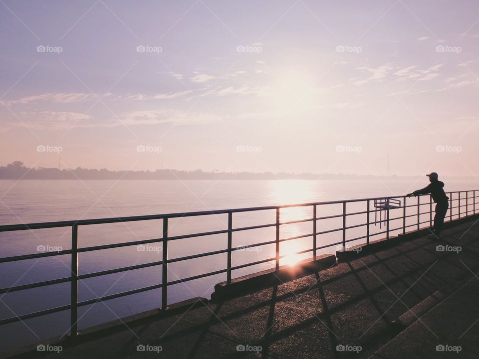 Man relaxing nearly river in the morning