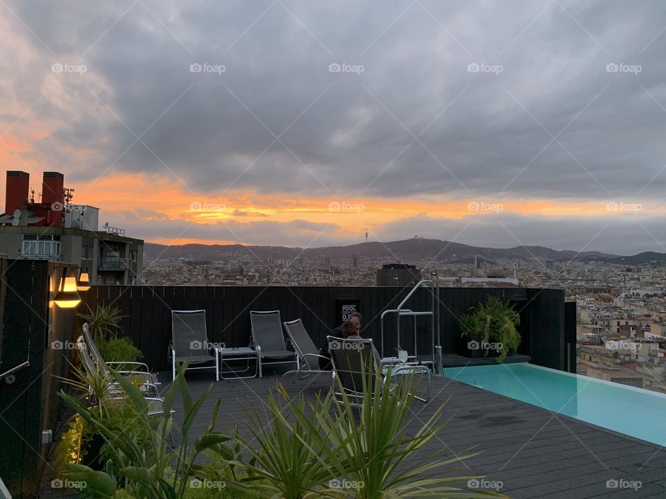Sunset at a rooftop swimming pool in Barcelona, Spain 