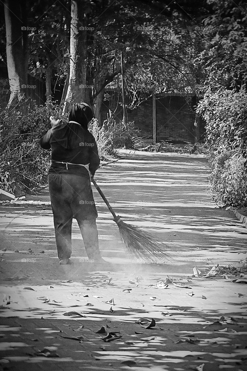 Woman who working as garden sweeper