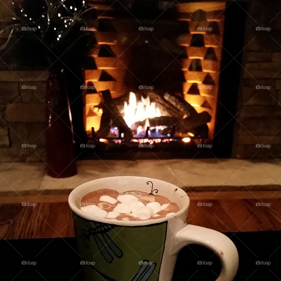 Hot Chocolate with Mashmellows in Mug by a Stack Stone  Fireplace